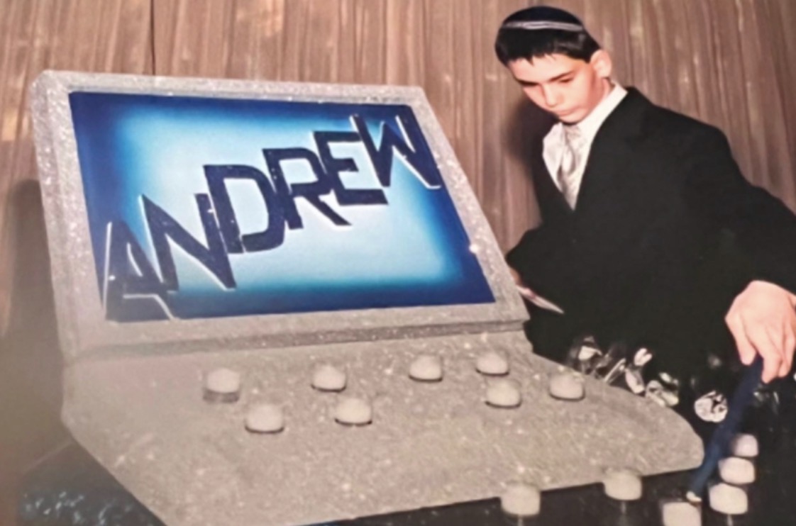 Andrew at his bar mitzvah with custom laptop cake displaying his name